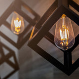 pear-shaped LED filament bulbs in open light fitting